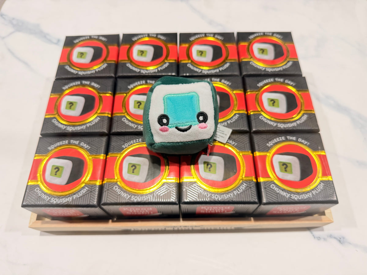 Knead That Sushi 12-pack blind box display with a sushi squishy plush on top